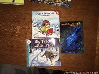 Front covers of the three children's books: Just a Snowy Day, Big Tracks Little Tracks, and Amphibians and Reptiles in 3D