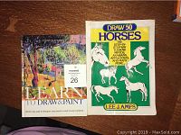 Two instructional art books side by side on a wood surface. Left book titled Learn To Draw & Paint by Curtis Tappenden, right book Draw 50 Horses by Lee J. James.