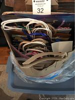 Top view of gift bags showing various handles made of rope and ribbon with different colors and patterns.