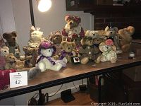 Photo of 23 Boyds Bear stuffed animals on table, various outfits and poses