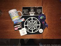 Full overview of joke gifts for aging including black dribble bib, chattering teeth, denture cream, buttons and mug.