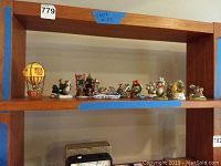 Wide view of shelf displaying all 11 ceramic mice figurines from the Charming Tails collection.
