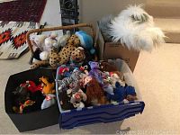 Overview of three containers filled with assorted Beanie Babies and plush toys including a large white plush dog and various animals with Ty tags.
