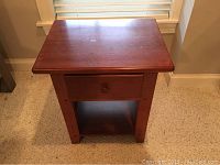 Pair of wooden Thomasville night tables with single drawer and lower shelf, showing tops and front faces.