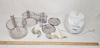Full set including Cuisinart food processor base, processing bowl, lid, blades, discs, and accessories laid out with ruler for size reference.