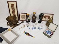 Full layout of lot showing framed art, decorative vases, egg, bronze bell and bowl, crystal figurines, ceramic dish, bird magnifier, and Mikimoto frame.