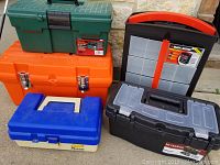 Side and top view of five assorted tool and tackle boxes in orange, green, blue-beige, black, and black-orange colors, showing external features and locking latches