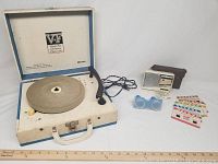 Full view of the lot with vintage record player, transistor radio with cord and earpiece, and stereoview slide cards.
