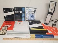 Full lot including multiple paper pads, Ottlite lamp, rulers, compass set, pencil and bulbs.