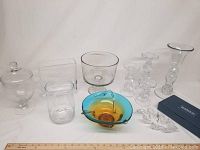 Full lot of assorted glassware on white background showing all items including the Waterford crystal dish, colorful bowl, trifle dish, candlesticks, and other glass vessels.