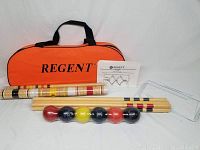 Full contents of the Regent croquet set including mallets, balls, stakes, carrying bag, and instruction manual.