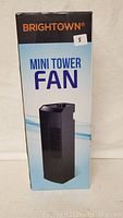 Front view of Brightown Mini Tower Fan box showing branding and fan image.