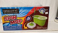 Gravitti Spin Mop box with product image showing the mop and bucket set. The box highlights the 360-degree rotating mop and ultra-absorbent microfiber mop head.
