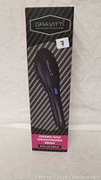 Box front showing Gravitti Ceramic Hair Straightening Brush with LCD display.