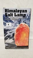 Front of the box showing the Himalayan Salt Lamp product image and claim that it is mined and chipped by hand in the Himalayan Mountains.