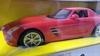 Close-up of the red Mercedes Benz SLS AMG remote control car displayed inside the box, showing detailed front and side view.