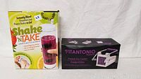 Shake 'N Take sports bottle blender box and Vitantonio French fry cutter box side by side on a white surface.