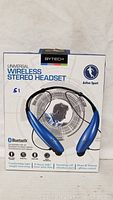 Front view of boxed ByTech wireless stereo headset showing product image and key features including Bluetooth compatibility and sport design.