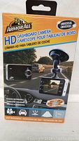 Front view of the ArmorAll HD dashboard camera packaging showing universal compatibility, camera image, and key features including always recording and 360-degree rotation.