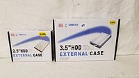 Both external HDD cases in original retail boxes, showing 2.5 inch and 3.5 inch sizes, labeled USB 2.0 and SATA interface.