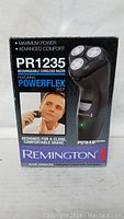 Front box view showing Remington PR1235 rechargeable cordless razor with PowerFlex 360° heads, maximum power and advanced comfort features.