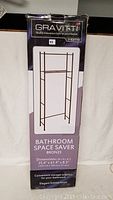Full front view of the Gravitti Bathroom Space Saver box showing brand, product name, and image of the assembled bronze rack.