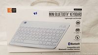 Photo of keyboard packaging showing front with image of white Caselogic mini bluetooth keyboard and branding