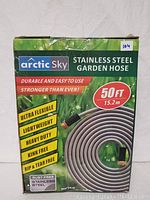 Box of Arctic Sky Stainless Steel Garden Hose showing branding, length specifications, and key features such as durability, flexibility, and rust-resistance.