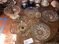 Overview of six crystal bowls and serving dishes arranged on table