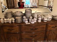 Full set displayed on sideboard, shows plates, cups, saucers, bowls, tea service and platters.