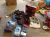 Photo showing men's vintage ties spread out on the floor alongside a men's short sleeve knit shirt and men's underwear packets, plus the boxed Old Spice Swagger gift set.