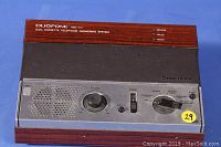 Front view of Radio Shack Duofone TAD-111 answering machine with wood grain finish, control knobs and switches, and speaker.