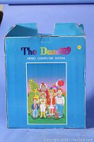 Blue cardboard box front with "The Diamond Video Computer System" logo and cartoon family illustration