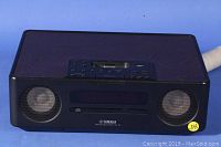 Front view of Yamaha desk top audio system showing dual speakers, CD slot, and Yamaha branding.