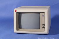 Front view of the vintage IBM 5151 monitor with black and white CRT screen and control knobs.