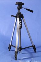 Full view of assembled Giottos VT806 tripod showing the silver aluminum legs, black tilt/pan head with handle and quick release camera mount.