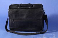 Front view of black leather laptop case with handle and zippered front pocket