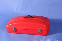 Closed red plastic carrying case with metal clasps, embossed with HOMELITE.