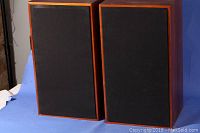 Pair of Marantz Imperial 7 speakers with new black grill cloth covering drivers, wood finish cabinets visible from front.