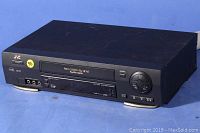 Front angled view of JVC HR-VP693U VHS VCR showing the entire unit with tape slot, control buttons, and brand label.