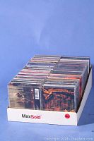 Photo of approximately 97 pop music CDs arranged vertically in a box.