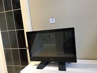 ViewSonic touchscreen monitor in upright position on stand, black frame with glossy screen.