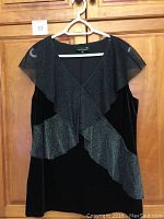 Front view of the black sleeveless velour and lace Laura Plus 14+ dressy top on a hanger.