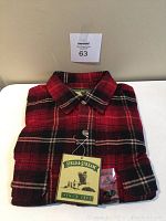 Folded men's long sleeve shirt in red and black plaid with original Field & Stream tag showing brand logo and since 1871.