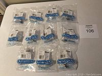 11 individually sealed Amerock cabinet knobs with installation screws visible in plastic packaging.