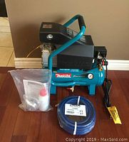 Front view of Makita MAC700 compressor showing handle, tank and housing