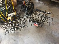 Wide view of two neon bar signs on the floor, one Kilian's Red and one Bud Light NFL with other beer signage in the background.