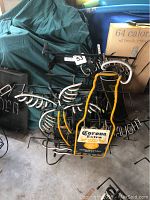 Overview of both unlit neon signs stacked on metal frames, showing Corona Extra bottle outline sign in front and Guinness sign behind.