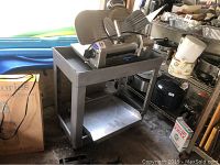 Chefmate deli meat slicer mounted on gray plastic utility cart