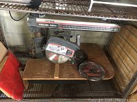 Full view of Sears Craftsman radial saw showing brand label, saw blade, and metal base.